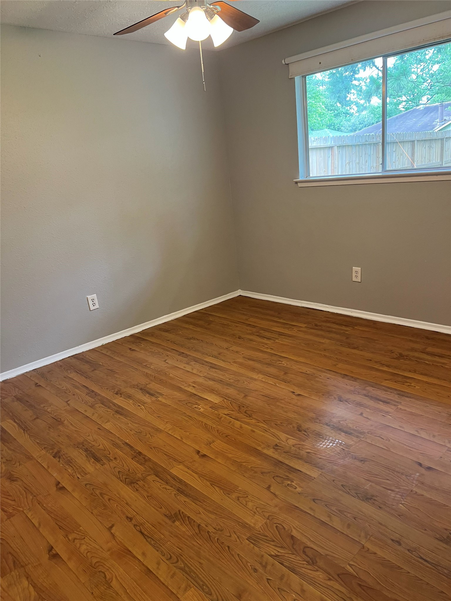 6507 Bridgegate Drive Spring, TX 77373 - Photo 9 of 17 a view of an empty room with wooden floor and a window