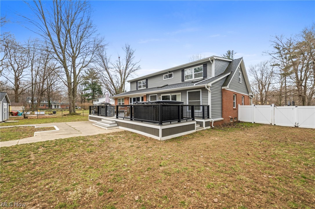 2425 McMackin Road Madison, OH 44057 - Photo 42 of 46 Rear view of house featuring a yard and a wooden deck