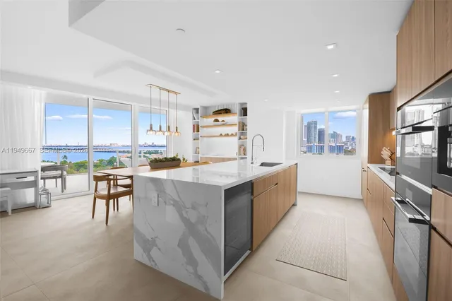 a large kitchen with stainless steel appliances lots of counter top space