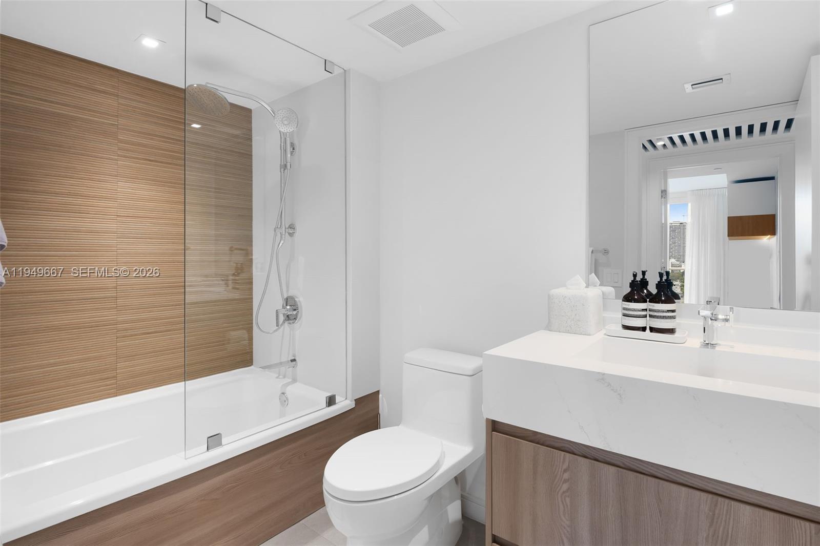 4250 Biscayne Boulevard, Unit 1201 Miami, FL 33137 - Photo 13 of 41 a bathroom with a sink a toilet and shower