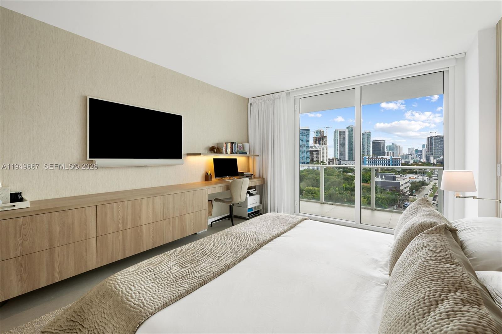 4250 Biscayne Boulevard, Unit 1201 Miami, FL 33137 - Photo 15 of 41 a living room with furniture and a flat screen tv