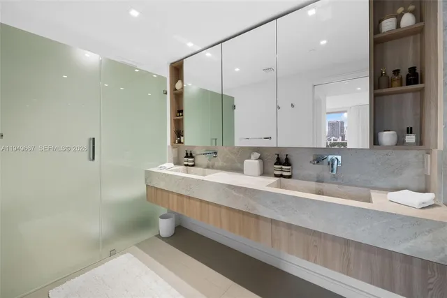 a bathroom with double vanity sinks double vanity and a shower