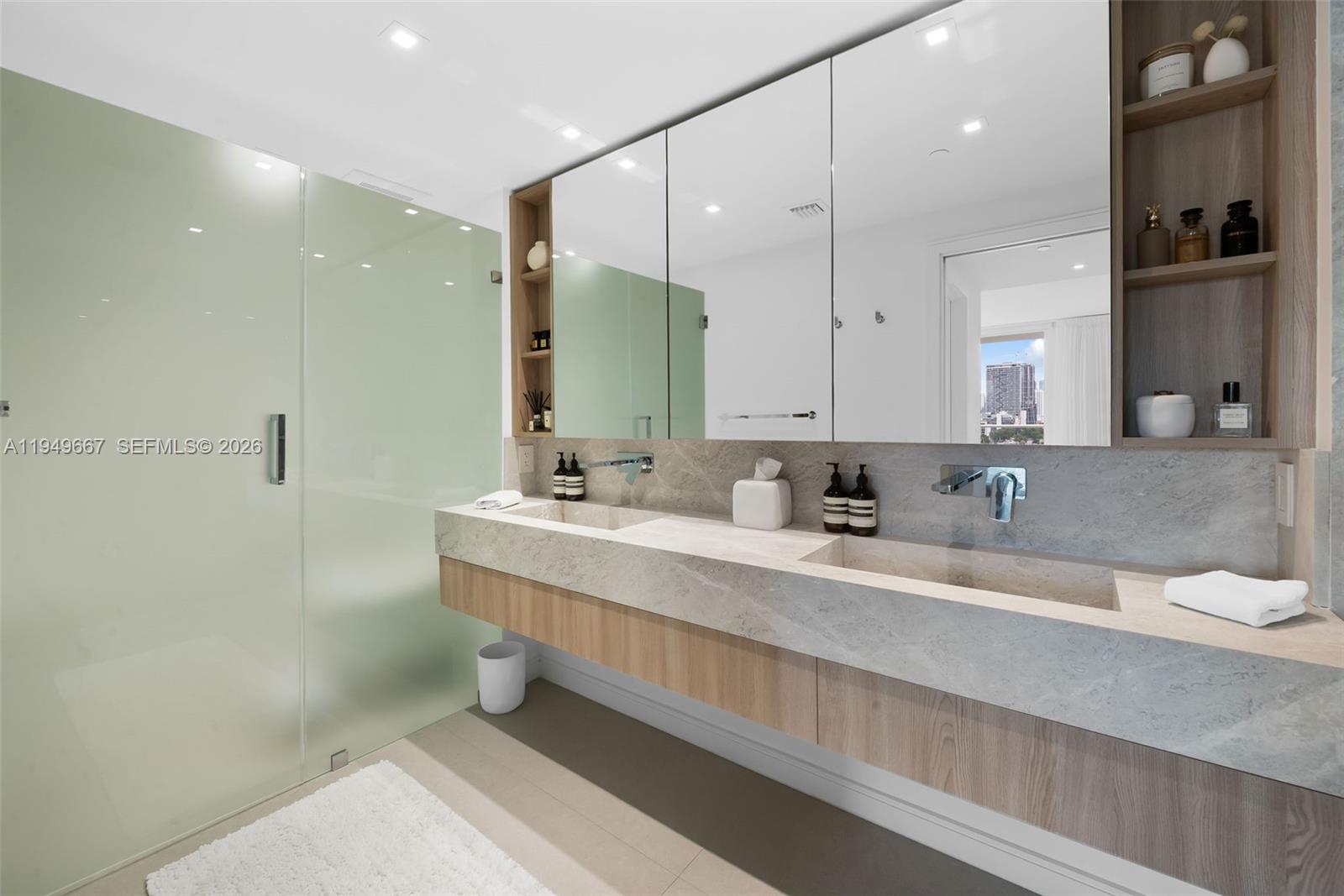 4250 Biscayne Boulevard, Unit 1201 Miami, FL 33137 - Photo 16 of 41 a bathroom with double vanity sinks double vanity and a shower
