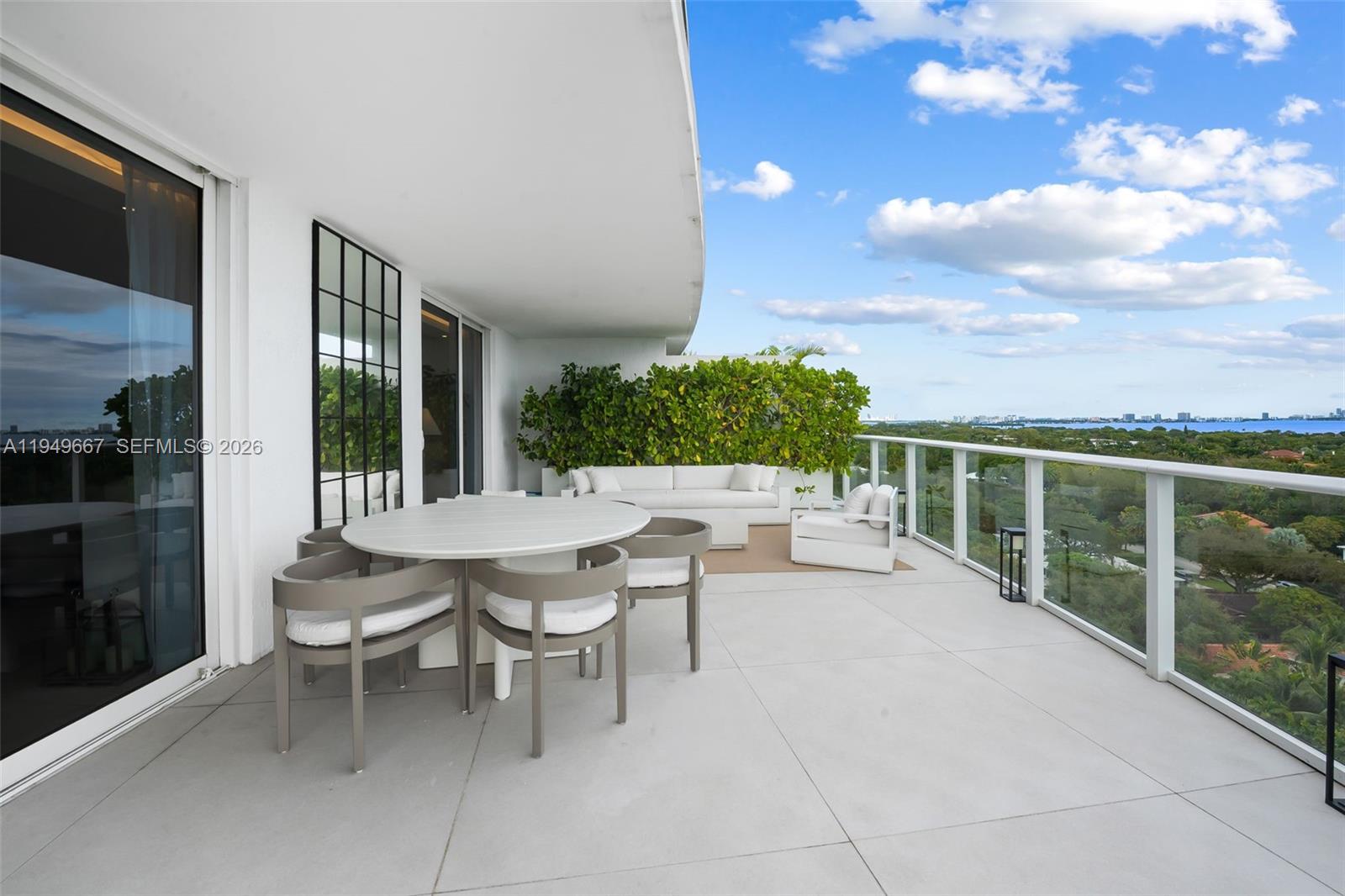 4250 Biscayne Boulevard, Unit 1201 Miami, FL 33137 - Photo 26 of 41 a view of a patio with couches table and chairs