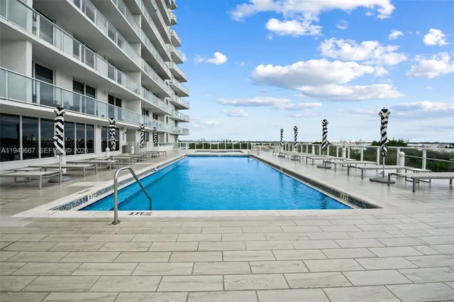 a view of a swimming pool with outdoor seating