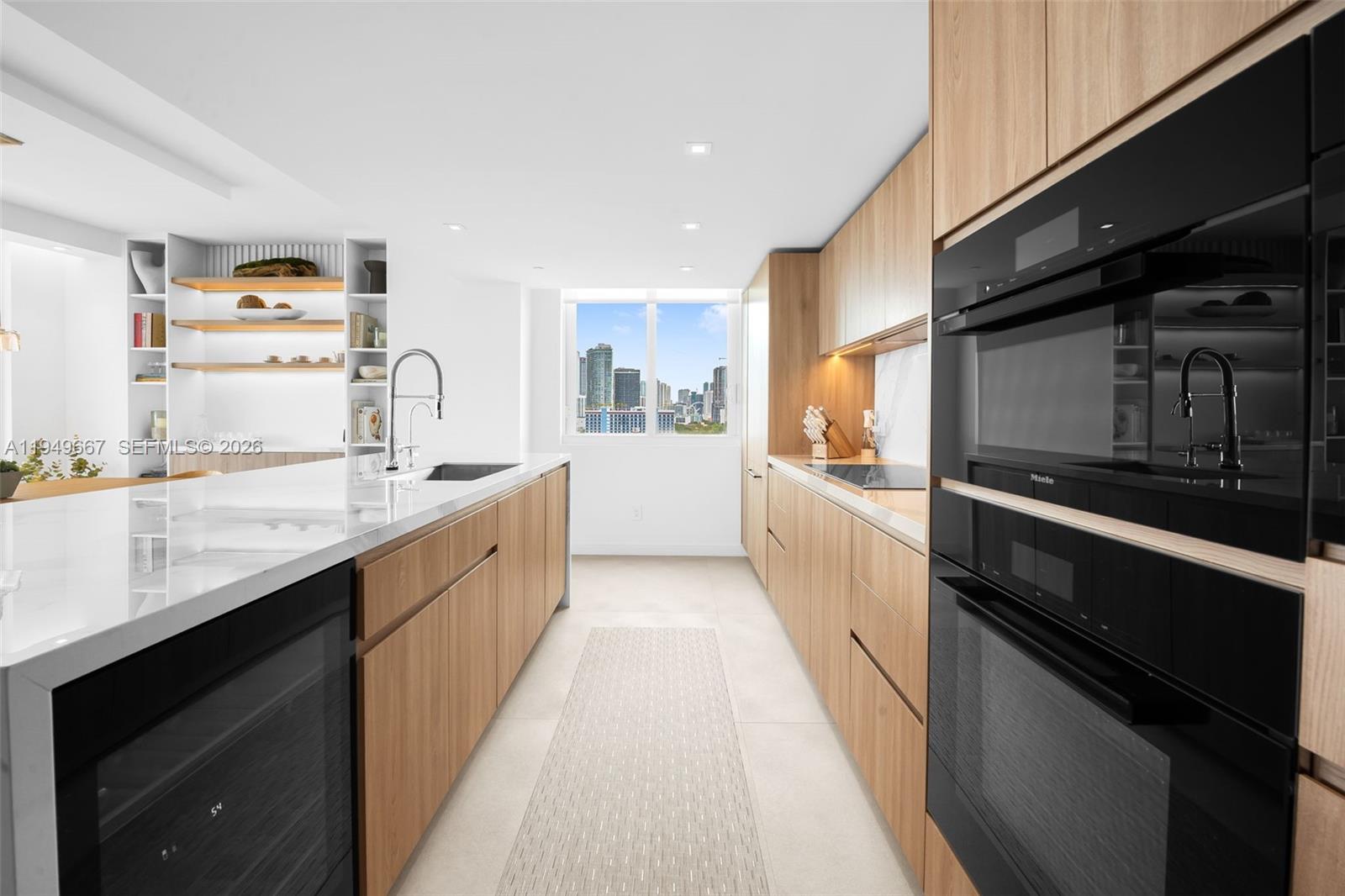 4250 Biscayne Boulevard, Unit 1201 Miami, FL 33137 - Photo 41 of 41 a large kitchen with a sink and dishwasher a stove top oven with wooden floor