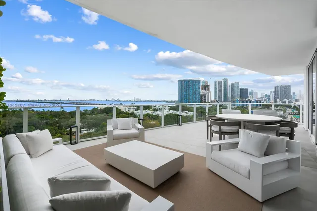 a living room with furniture and a view of kitchen