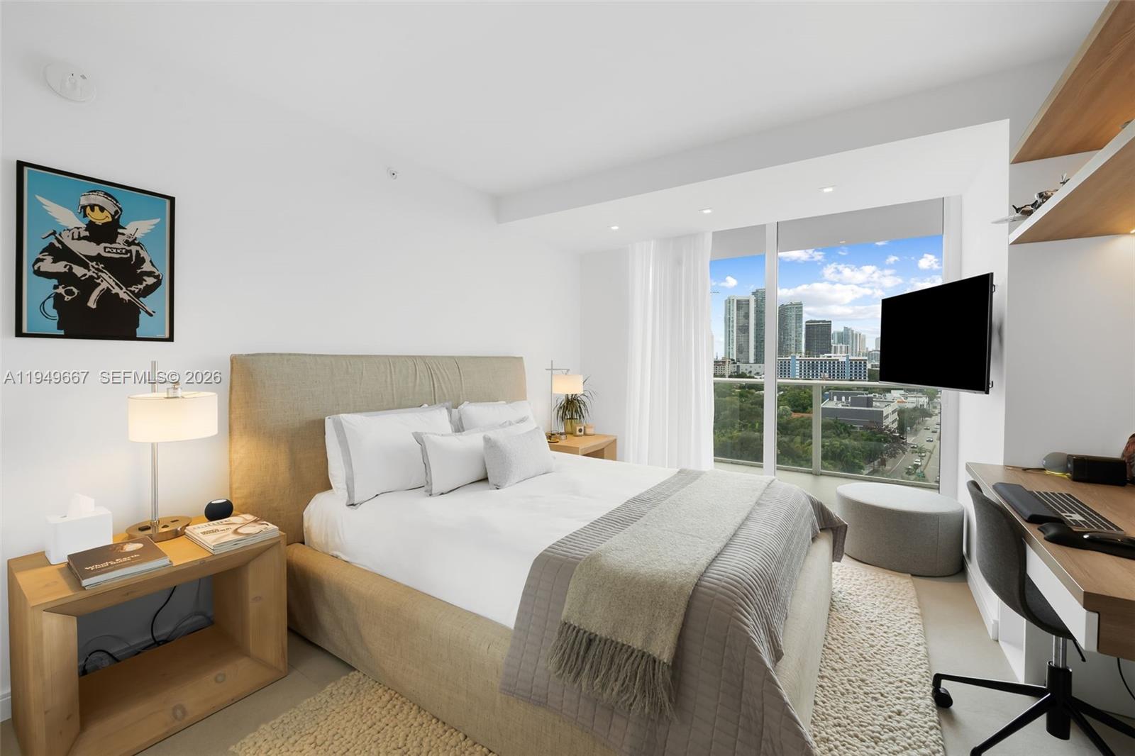 4250 Biscayne Boulevard, Unit 1201 Miami, FL 33137 - Photo 10 of 41 a bedroom with a bed and a flat screen tv