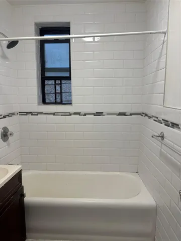 a bathroom with bathtub and shower