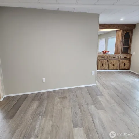 a view of a room with wooden floor and cabinet