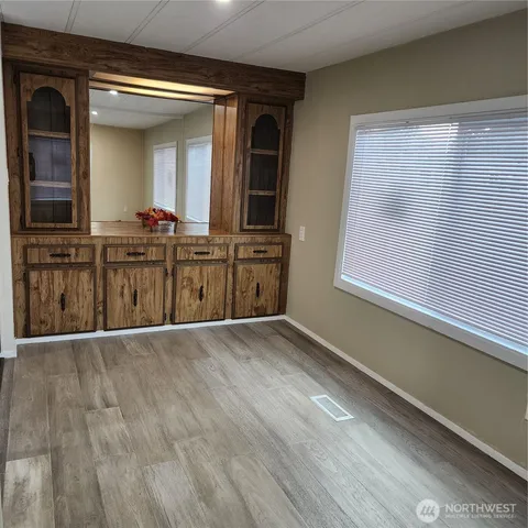 a view of a kitchen cabinets and a wooden floor