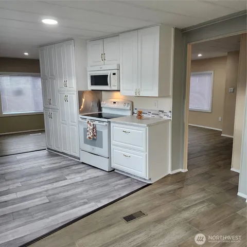 a kitchen with stainless steel appliances a stove top oven and cabinets