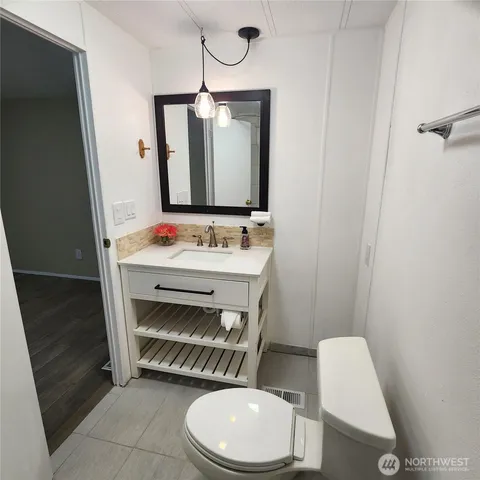 a bathroom with a toilet a sink and a mirror