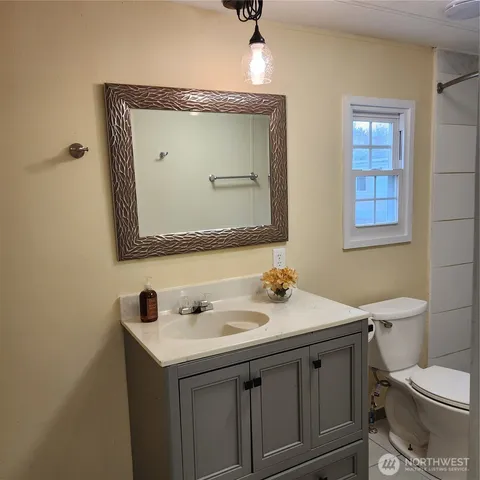 a bathroom with a toilet sink and mirror
