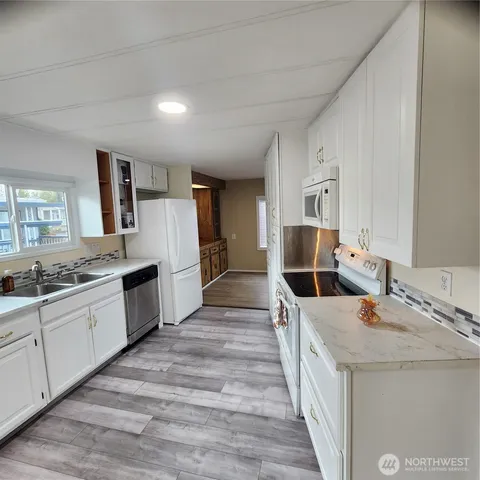 a large kitchen with a stove and kitchen island