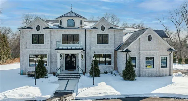a view of a white house with a clock on the wall and windows