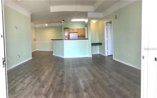 a view of kitchen and hall with wooden floor