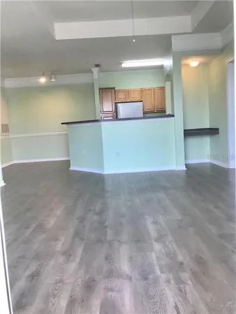 an empty room with a empty space and windows