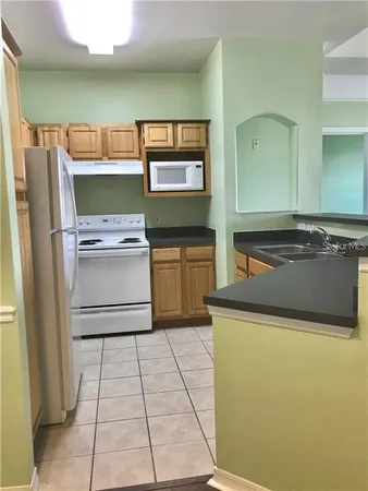 a kitchen with stainless steel appliances granite countertop a refrigerator and a stove