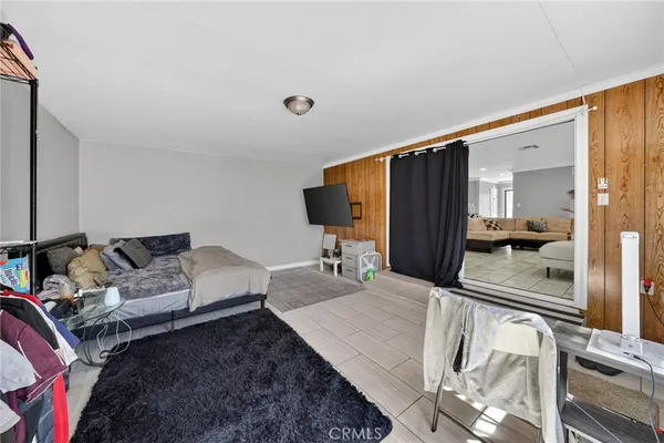 a kitchen with stainless steel appliances granite countertop a refrigerator oven a sink a dining table and chairs with white cabinets
