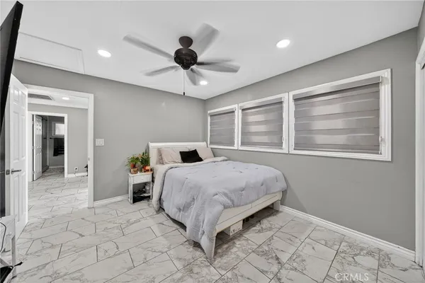 a living room with furniture kitchen view and a window