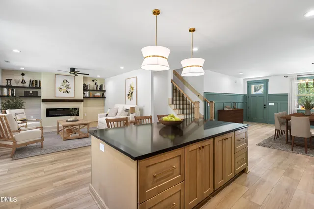 a kitchen with stainless steel appliances granite countertop a sink stove and wooden floor