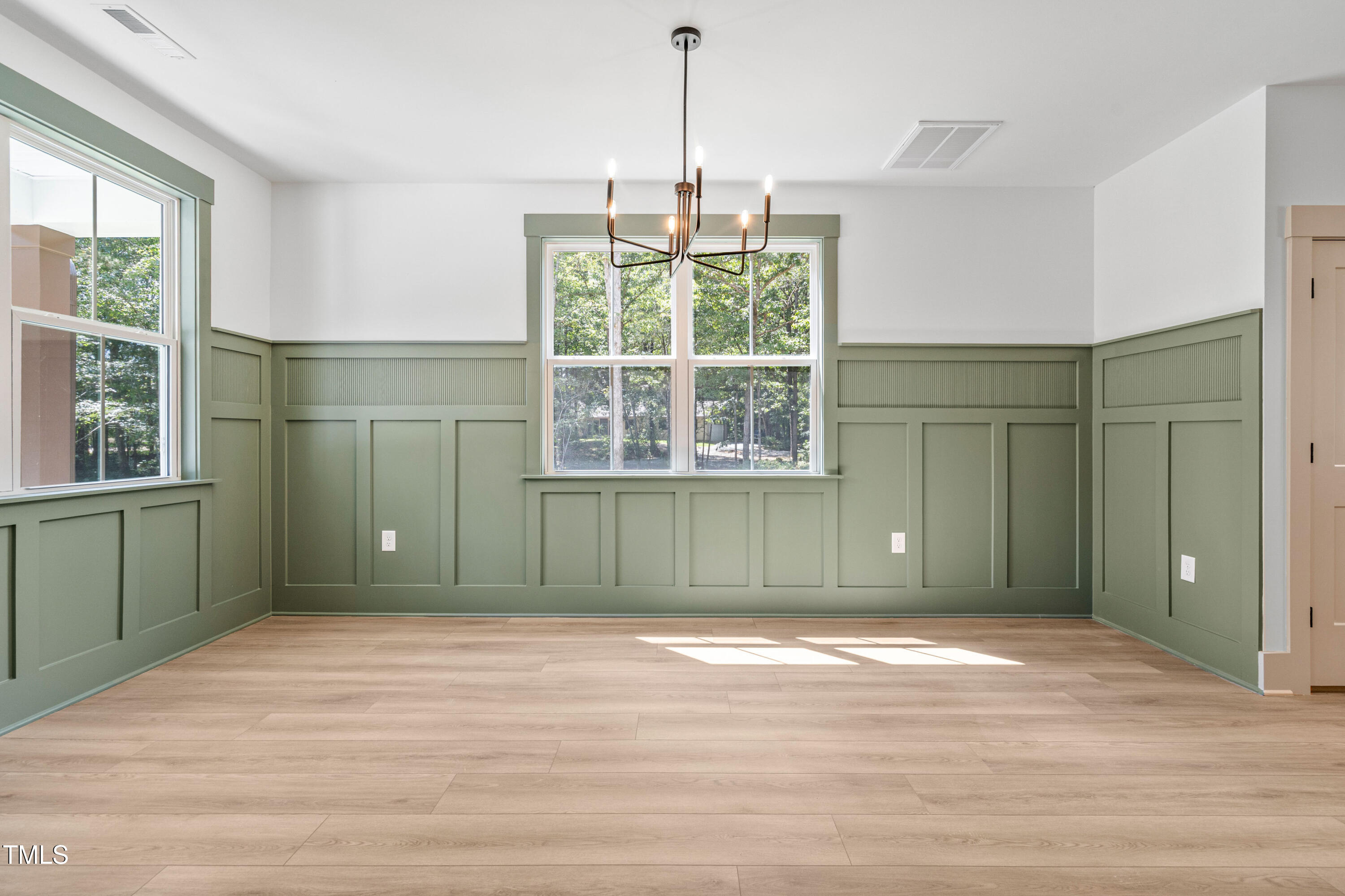 312 Russ Road Smithfield, NC 27577 - Photo 12 of 60 a view of a room with window walk in closet and wooden floor