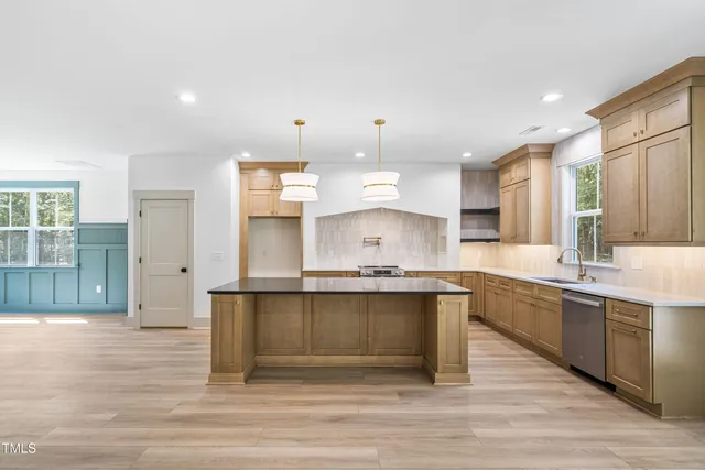 a large kitchen with a sink and cabinets