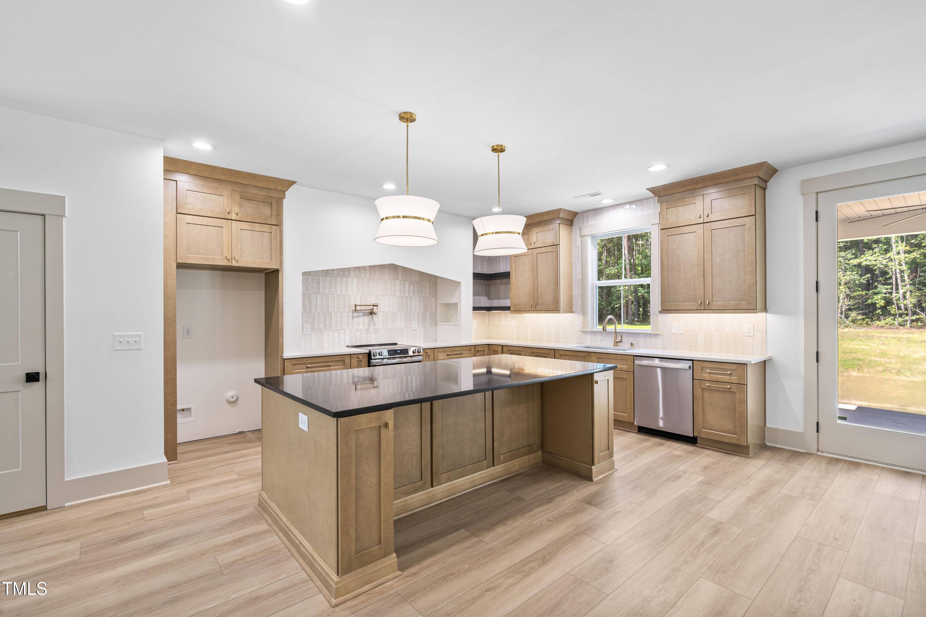 312 Russ Road Smithfield, NC 27577 - Photo 17 of 60 a kitchen with a stove a sink a refrigerator and window