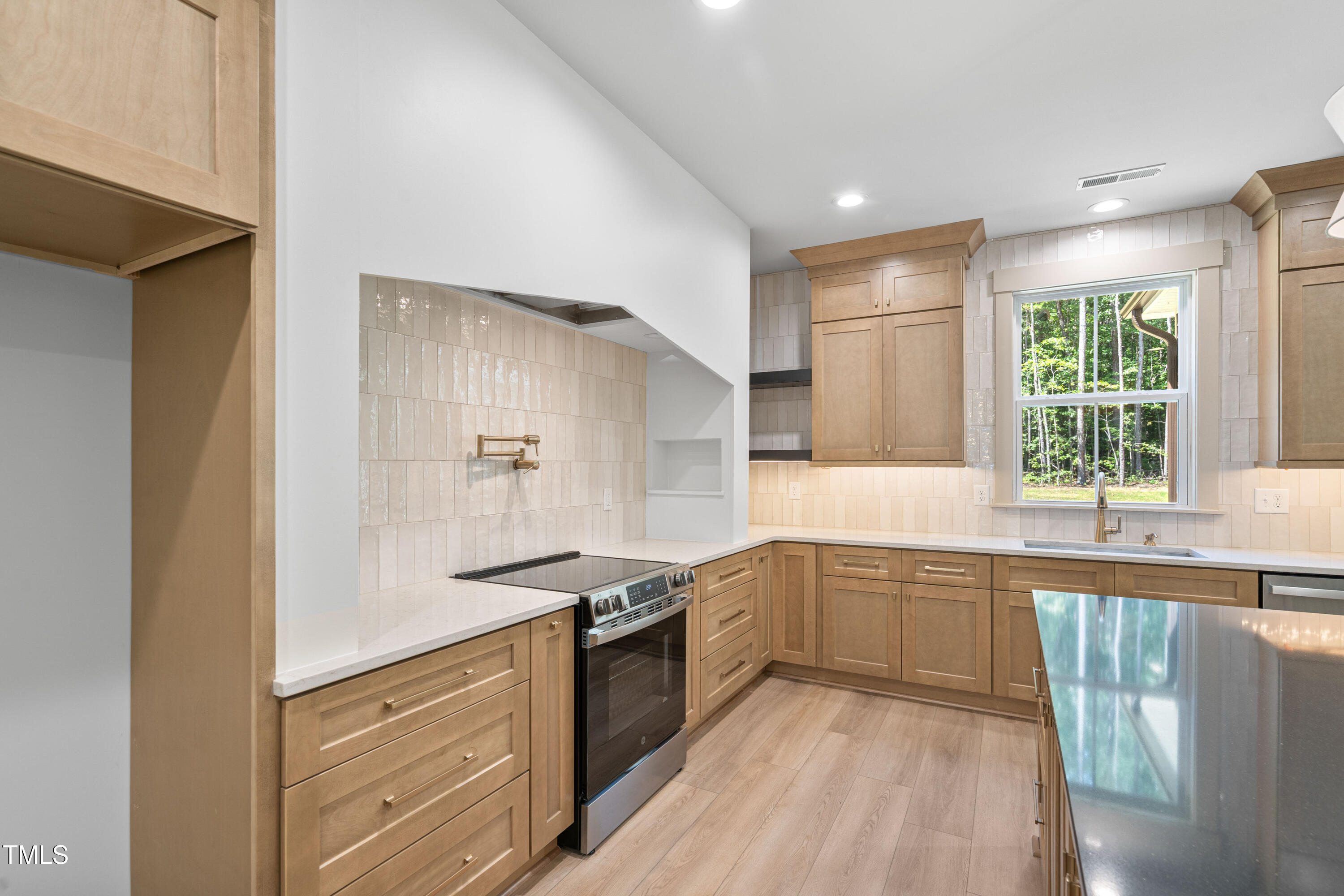 312 Russ Road Smithfield, NC 27577 - Photo 18 of 60 a kitchen with stainless steel appliances granite countertop a sink and a stove