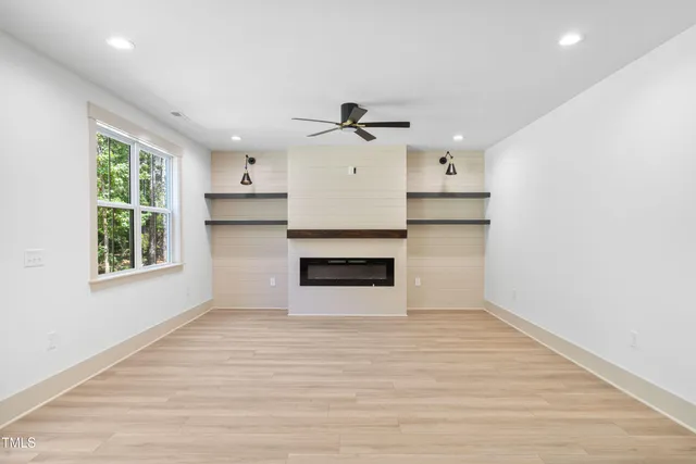 a view of a hallway with wooden floor and entryway