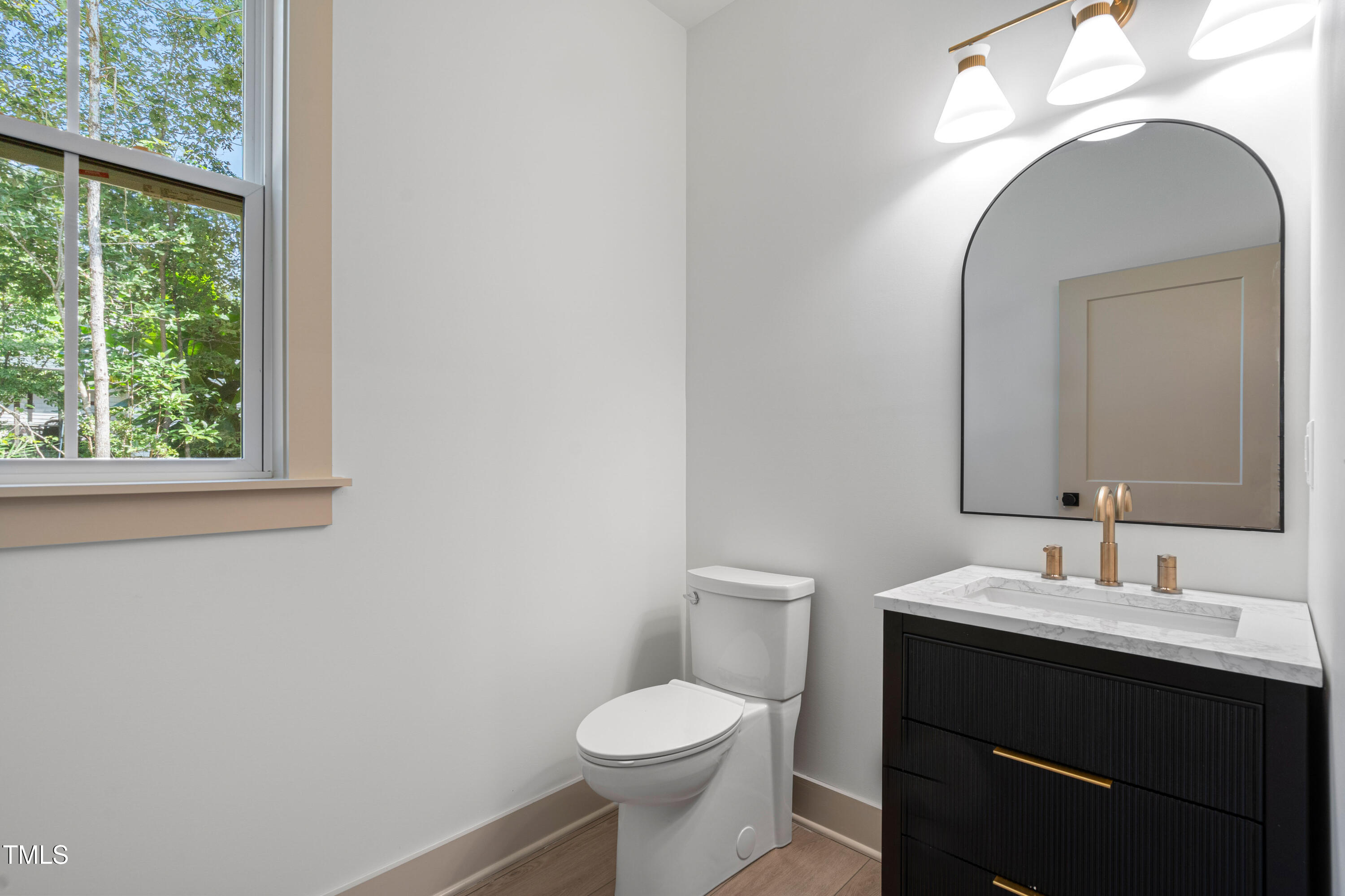 312 Russ Road Smithfield, NC 27577 - Photo 25 of 60 a bathroom with a toilet a sink and a mirror