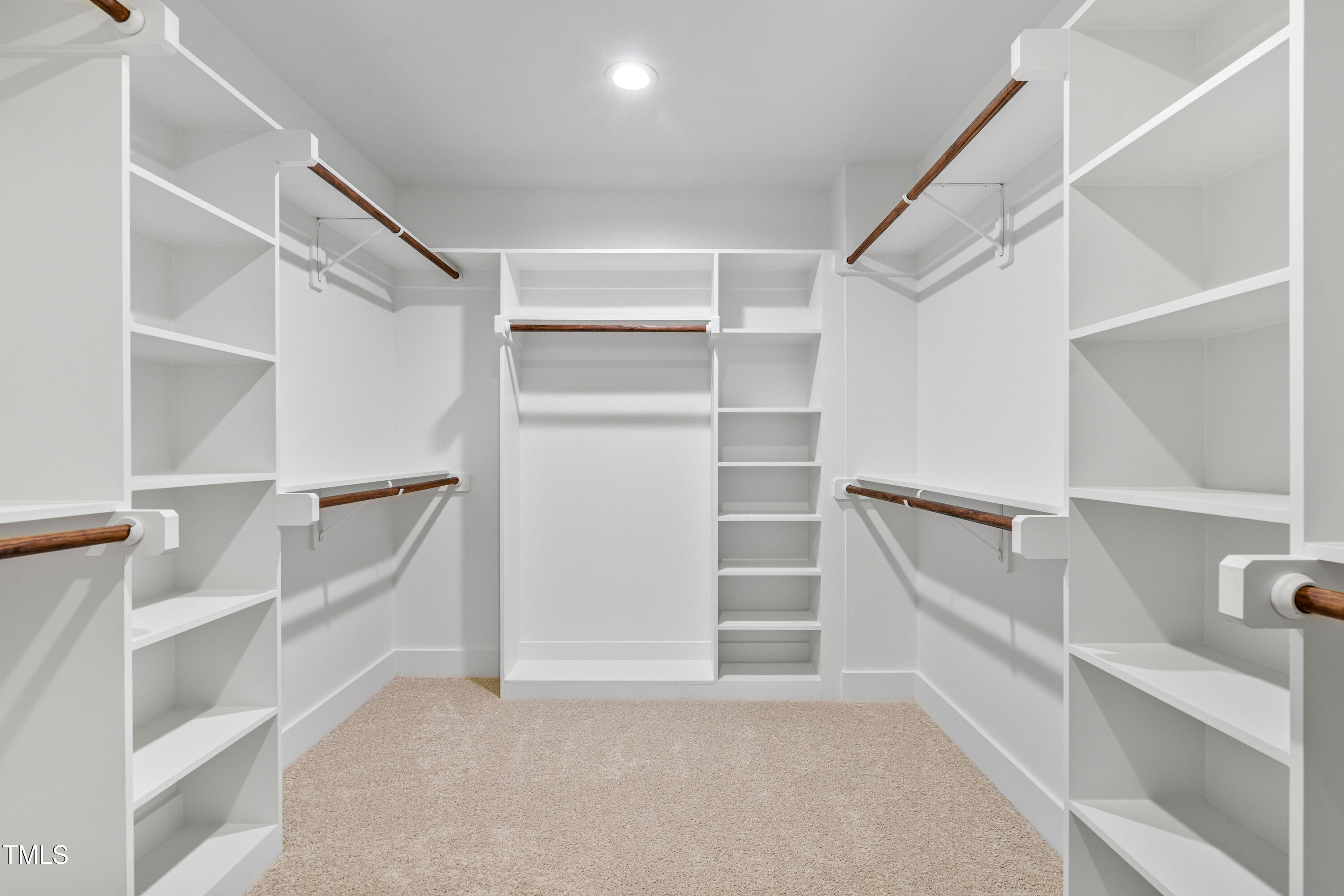 312 Russ Road Smithfield, NC 27577 - Photo 32 of 60 a view of walk in closet with empty racks