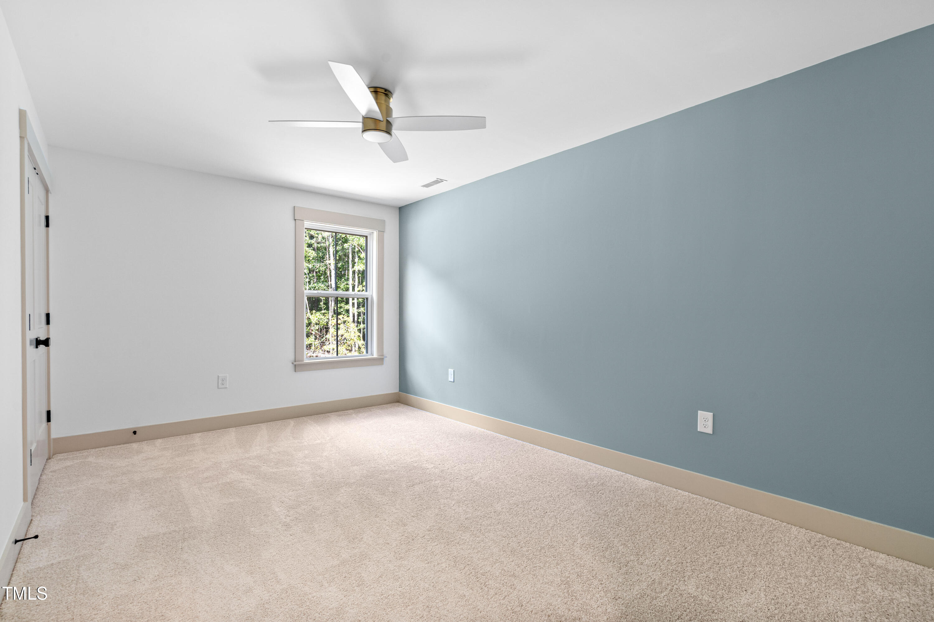 312 Russ Road Smithfield, NC 27577 - Photo 34 of 60 an empty room with a window and a ceiling fan