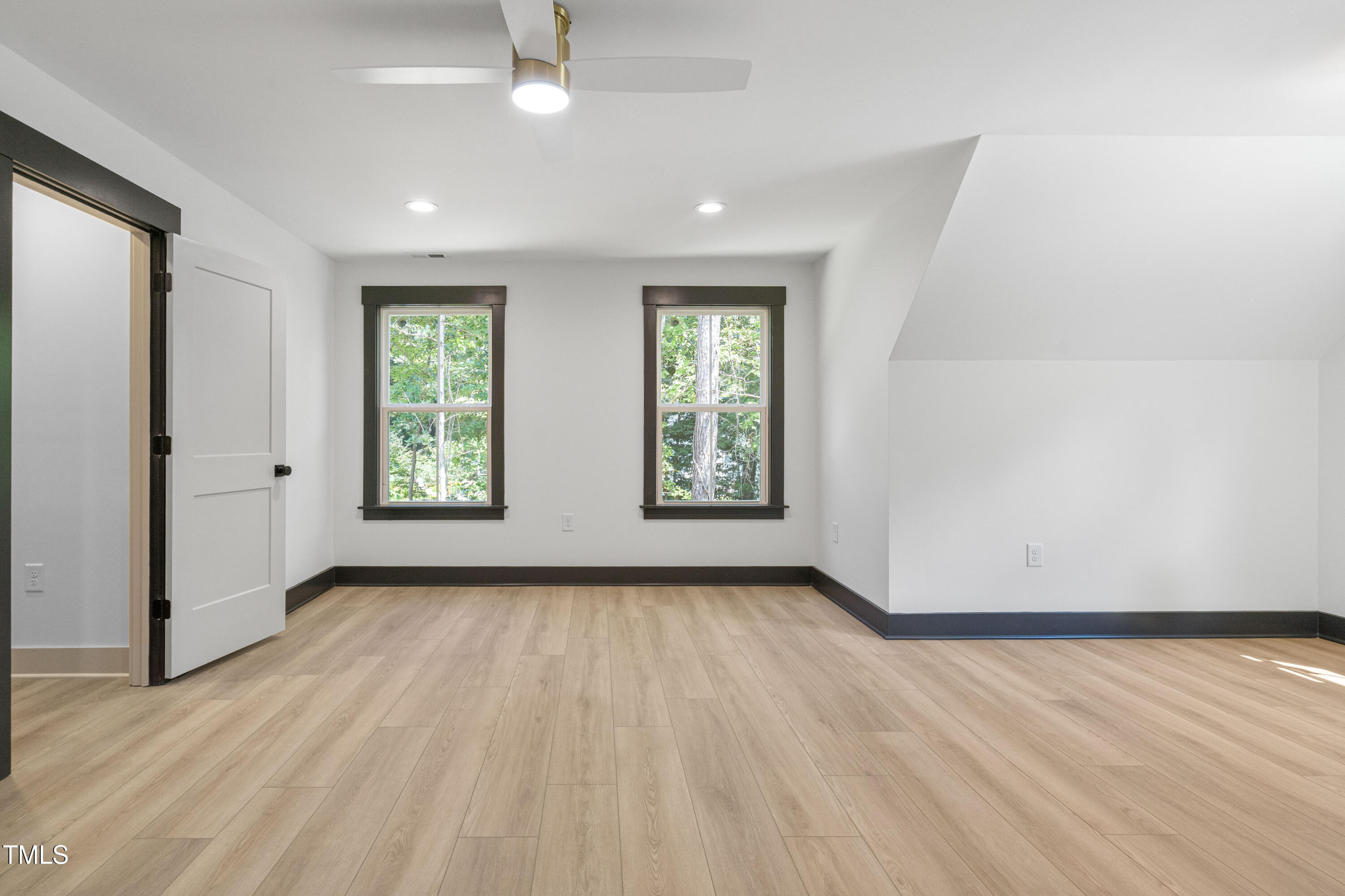 312 Russ Road Smithfield, NC 27577 - Photo 41 of 60 an empty room with wooden floor and windows