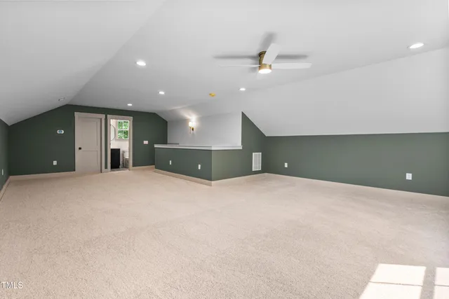 a view of a livingroom with a ceiling fan and window