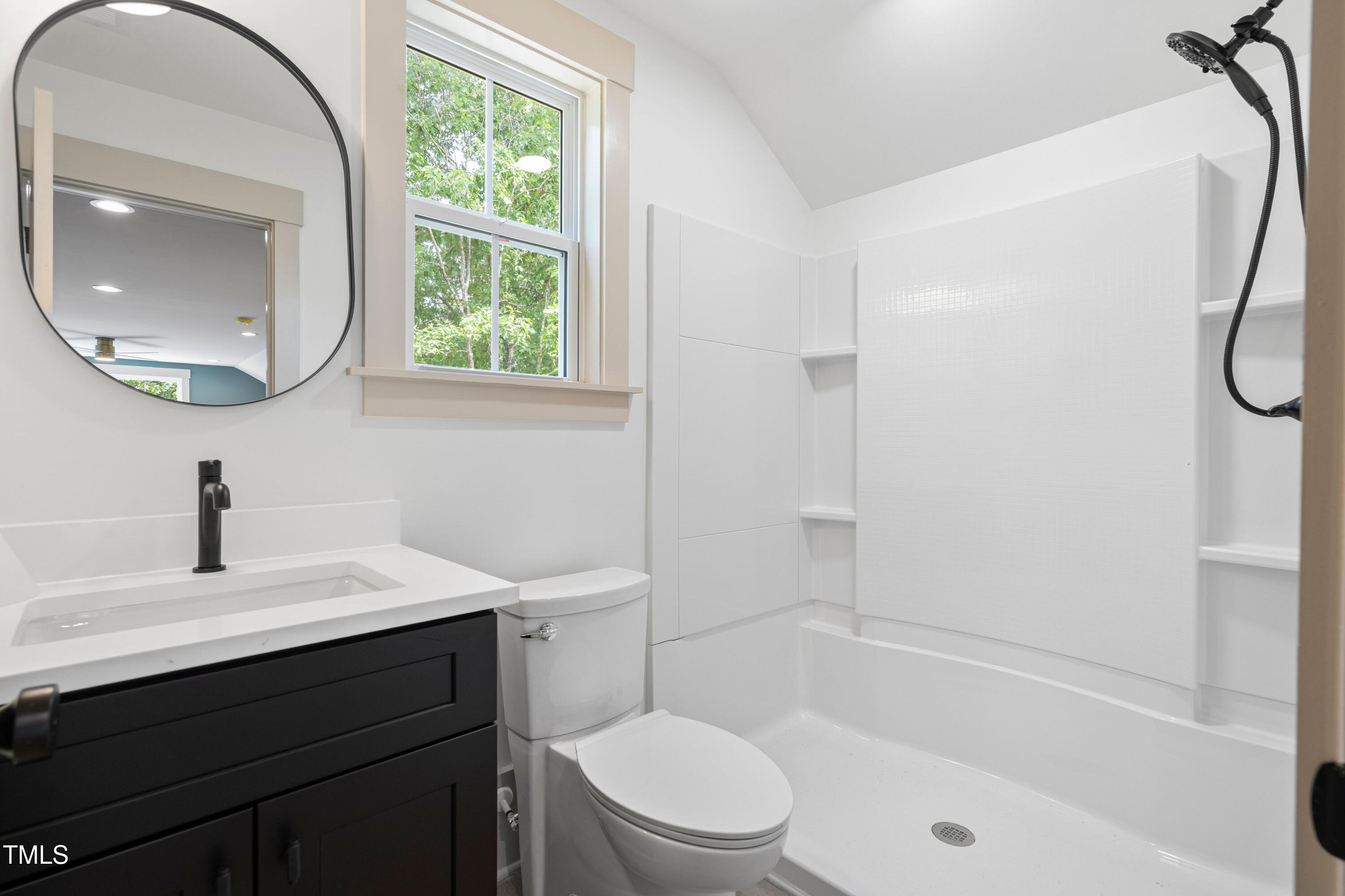 312 Russ Road Smithfield, NC 27577 - Photo 45 of 60 a bathroom with a sink a toilet and a mirror