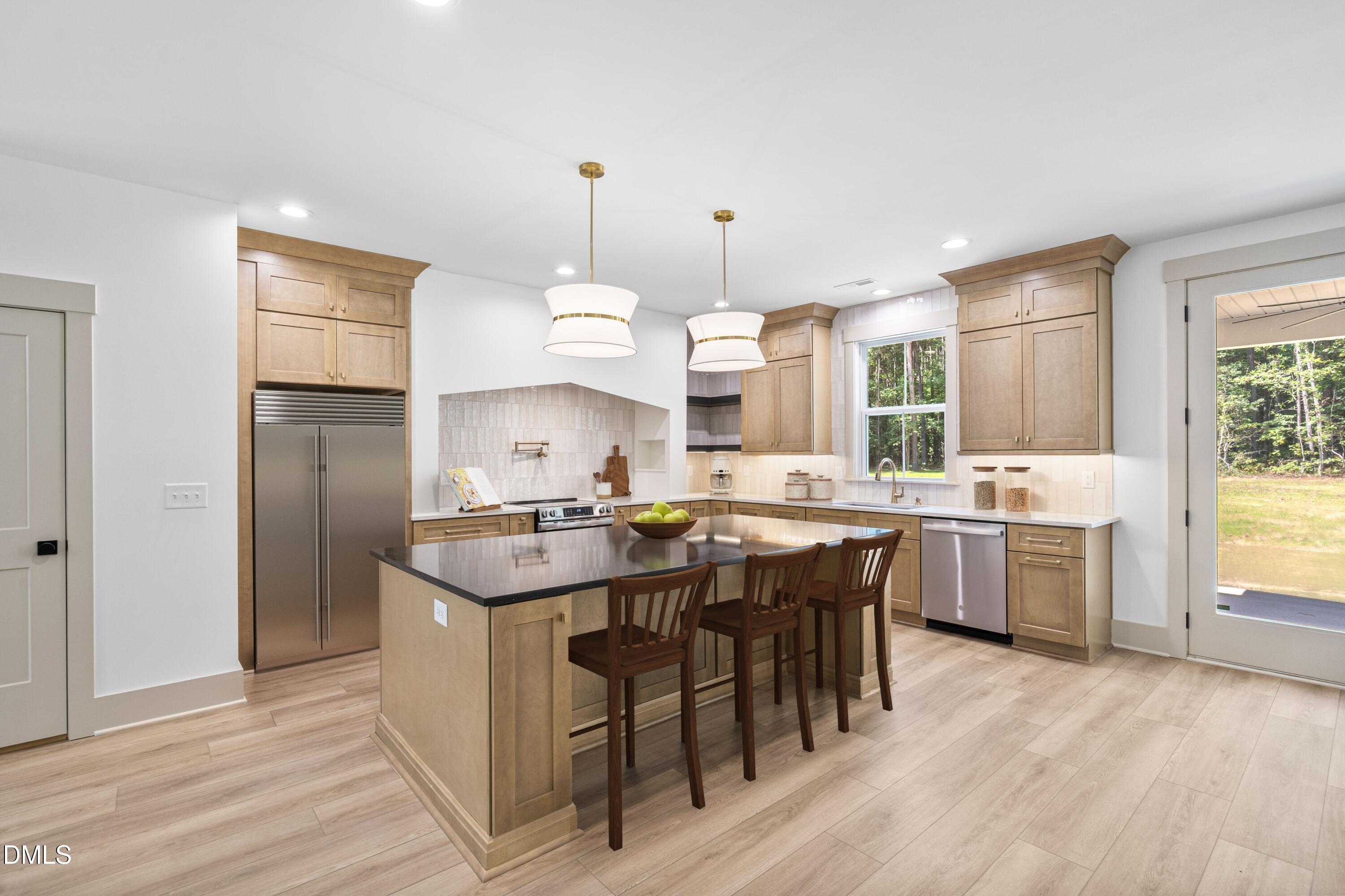 312 Russ Road Smithfield, NC 27577 - Photo 4 of 60 a kitchen with a sink a counter top space and stainless steel appliances