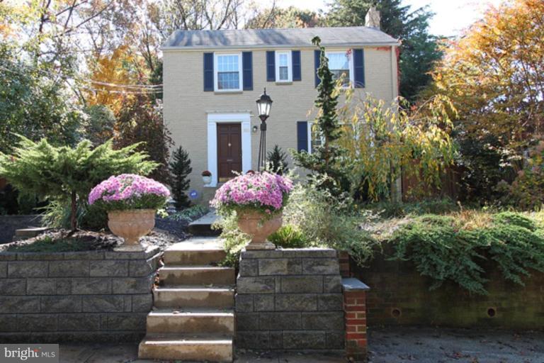a front view of a house with plants