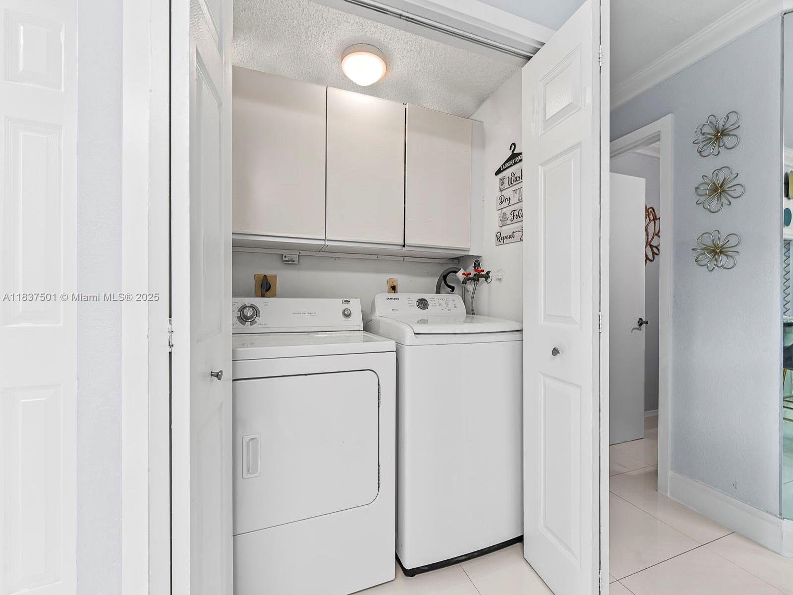 10942 West Sample Road, Unit E1 Coral Springs, FL 33065 - Photo 15 of 32 a view of a storage & utility room with dryer and washer