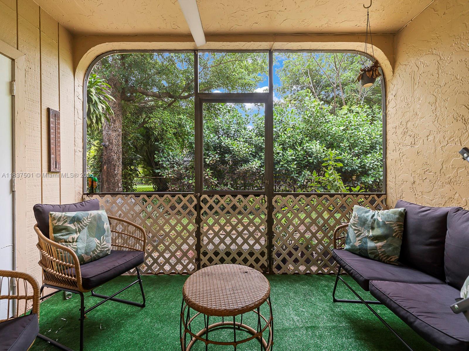 10942 West Sample Road, Unit E1 Coral Springs, FL 33065 - Photo 16 of 32 a living room with furniture and a large window