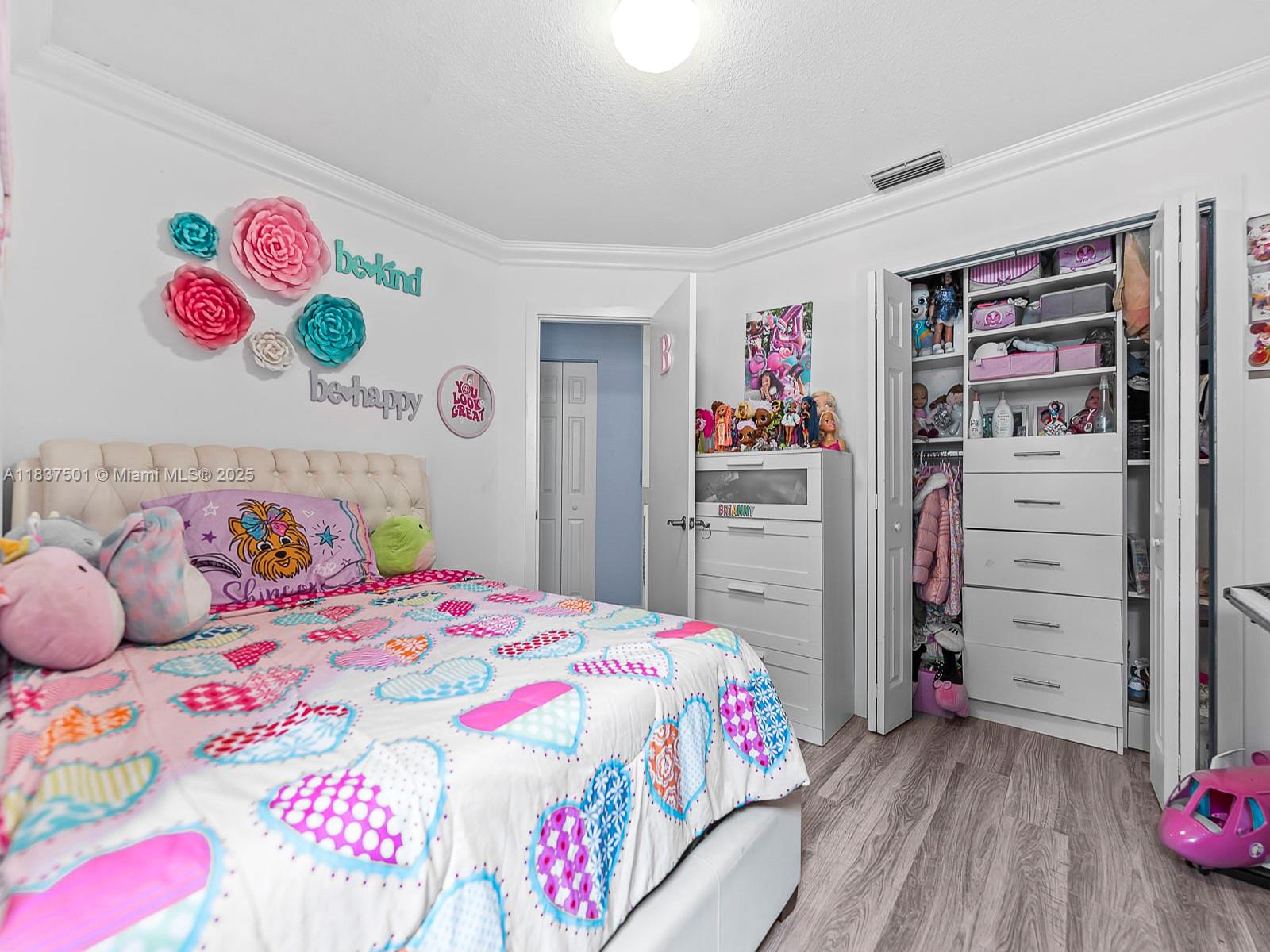 10942 West Sample Road, Unit E1 Coral Springs, FL 33065 - Photo 22 of 32 a bedroom with a bed and cabinets