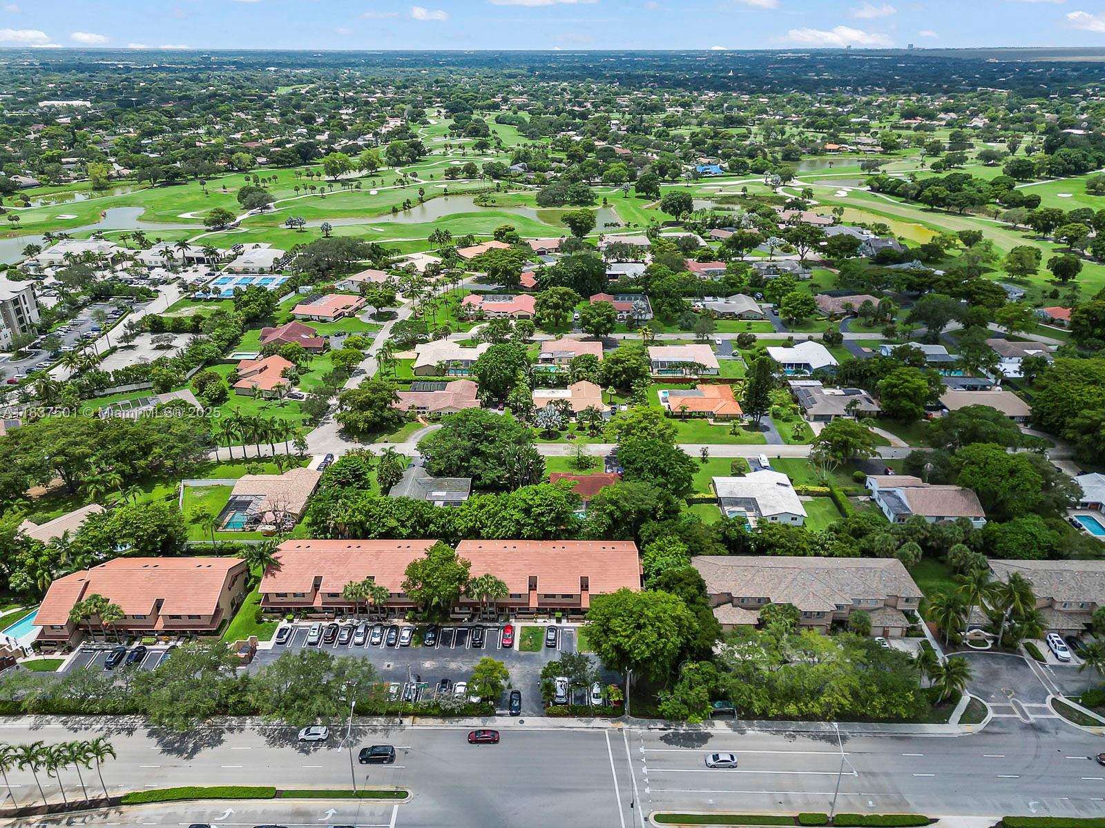 10942 West Sample Road, Unit E1 Coral Springs, FL 33065 - Photo 27 of 32 an aerial view of a house with a yard