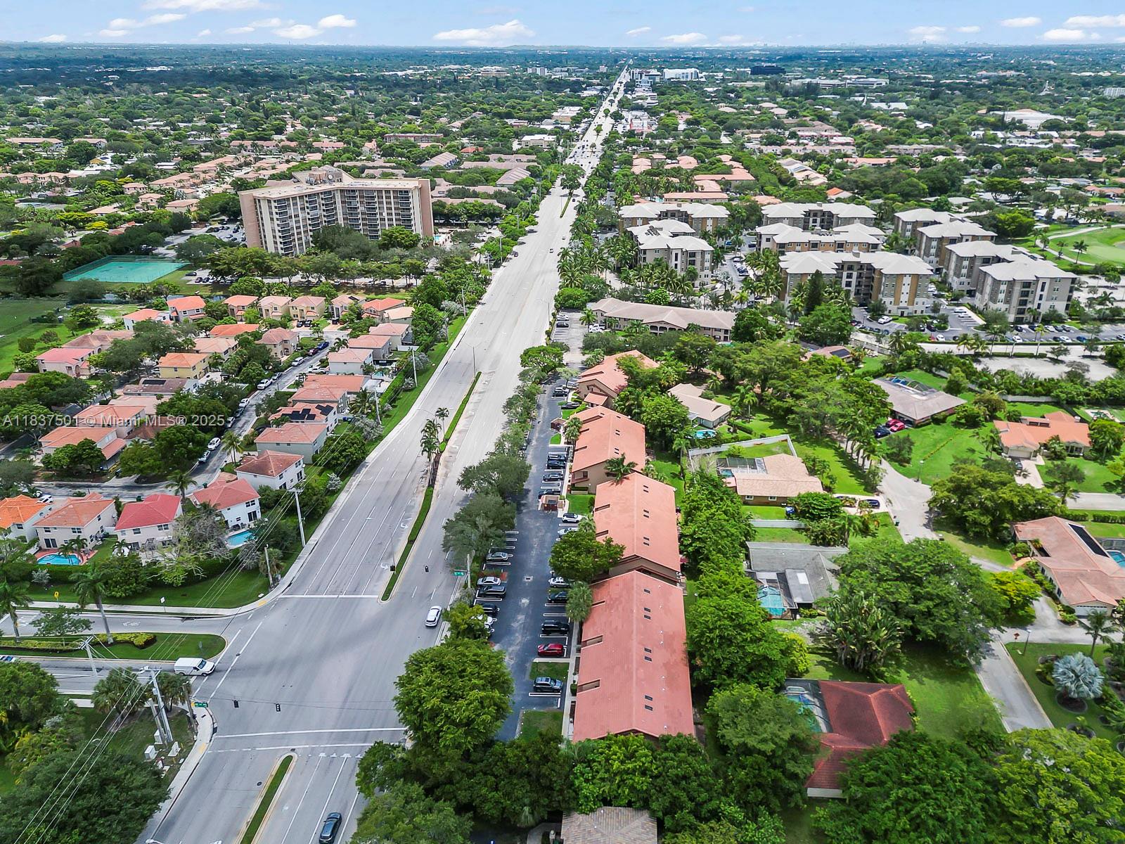 10942 West Sample Road, Unit E1 Coral Springs, FL 33065 - Photo 28 of 32 an aerial view of residential houses with outdoor space and street view