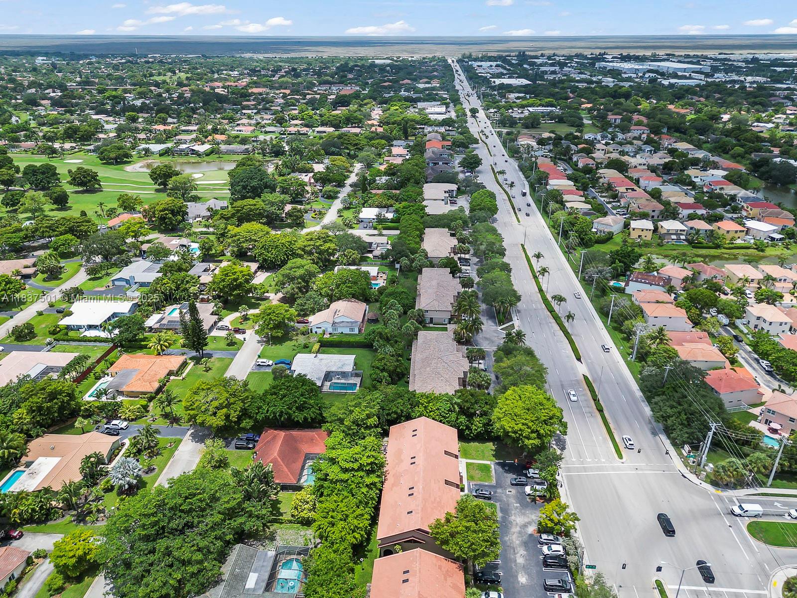 10942 West Sample Road, Unit E1 Coral Springs, FL 33065 - Photo 30 of 32 an aerial view of residential houses with outdoor space