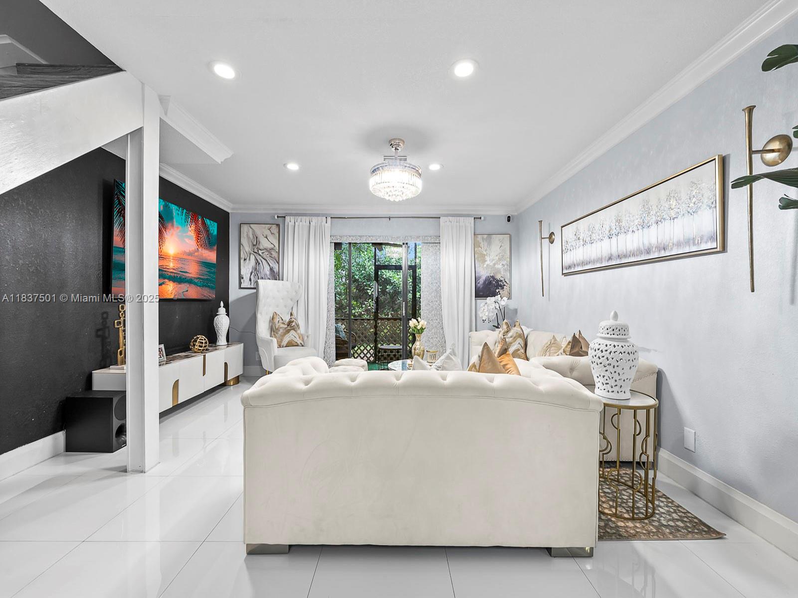 10942 West Sample Road, Unit E1 Coral Springs, FL 33065 - Photo 3 of 32 a room with a bed a flat screen tv and window