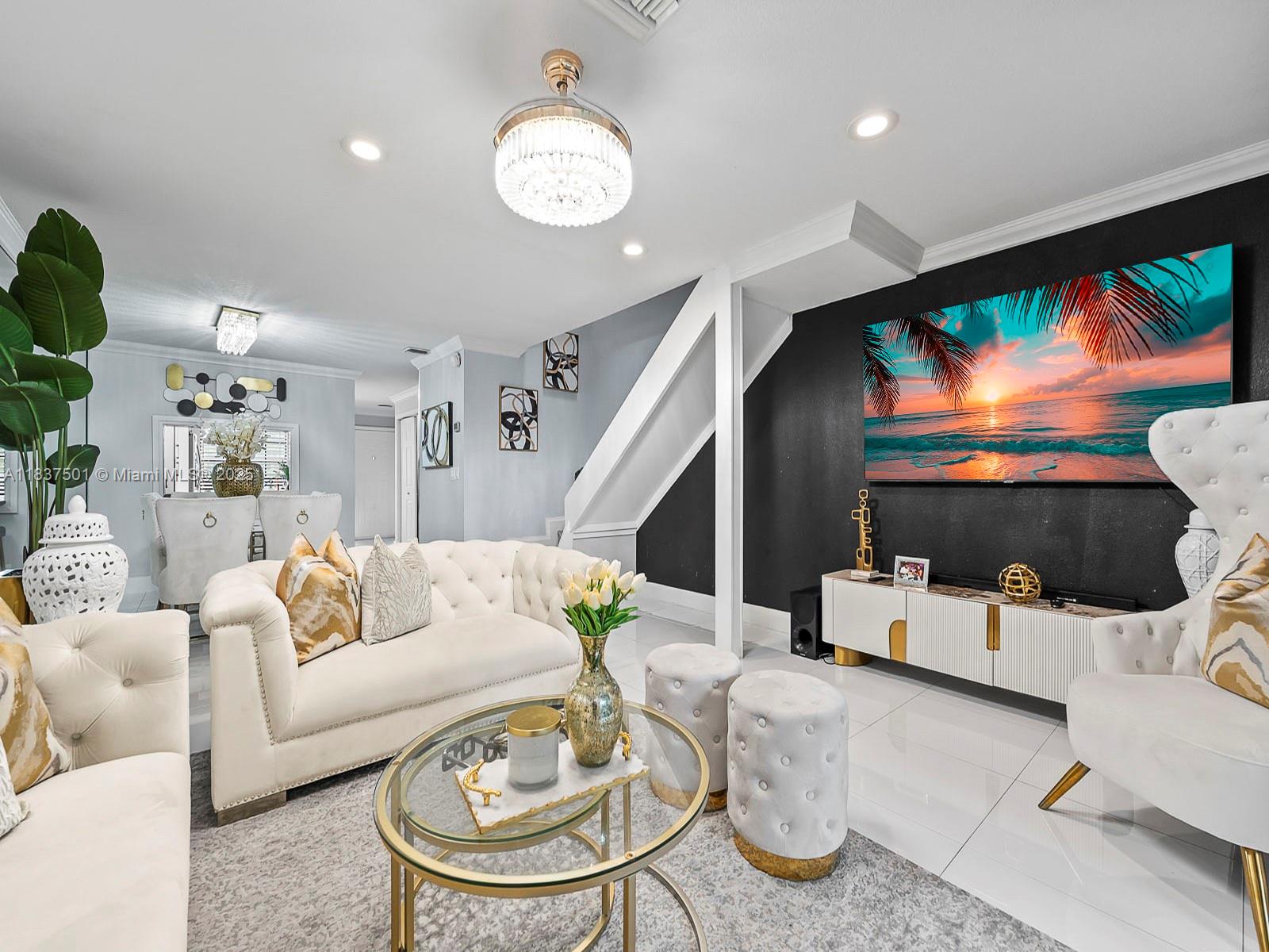 10942 West Sample Road, Unit E1 Coral Springs, FL 33065 - Photo 7 of 32 a living room with furniture and a flat screen tv