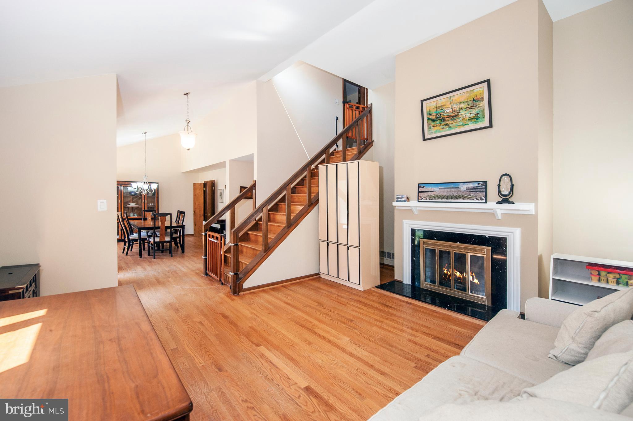 513 Flora Circle Springfield, PA 19064 - Photo 3 of 28 a living room with wooden floor and a fireplace