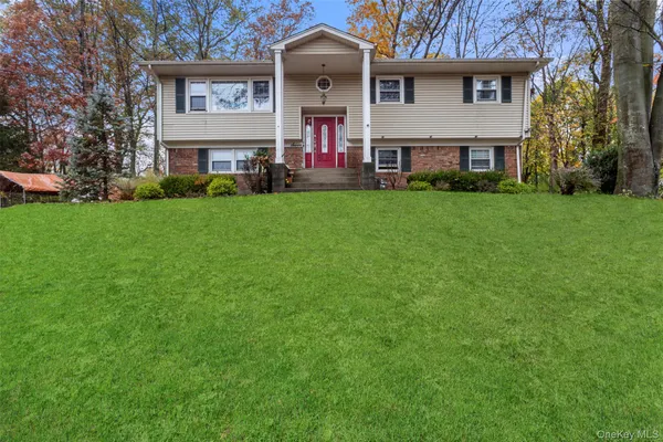 a front view of a house with a garden and plants