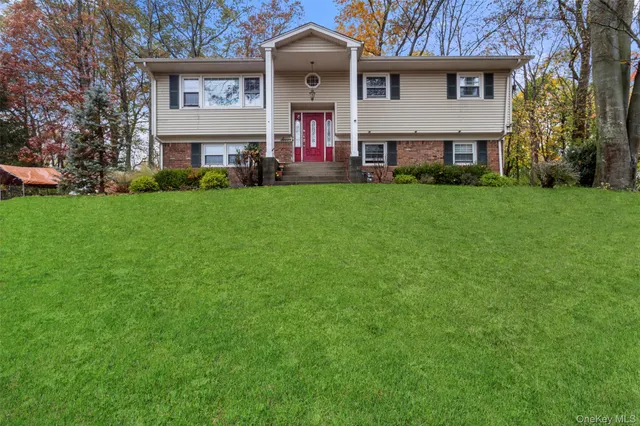 a front view of a house with a garden and plants